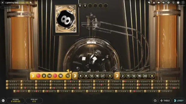 Lightning Ball drawing machine pulling numbered balls during a live round with the number grid below