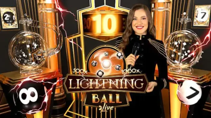 Lightning Ball Live host standing between the two ball-drawing machines in the studio